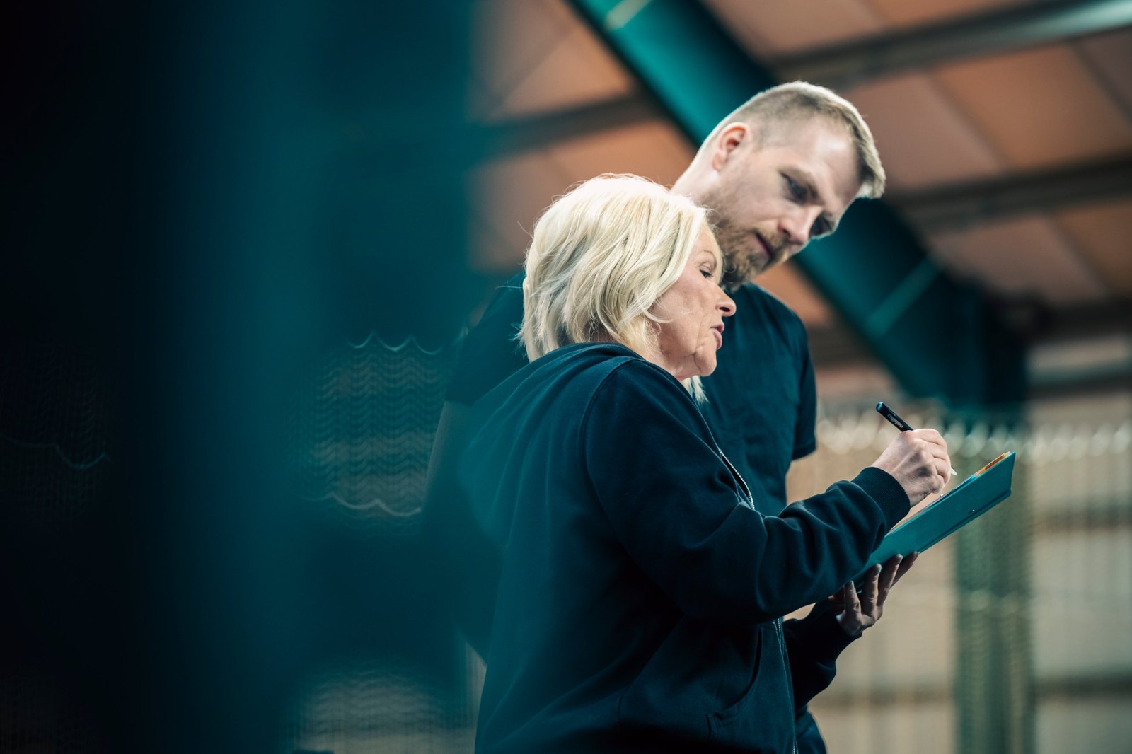 Anja Lorenz und ein Teilnehmer arbeiten gemeinsam an einer Mappe